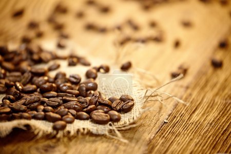 Fresh coffee beans on wood background, Macro close-up for design