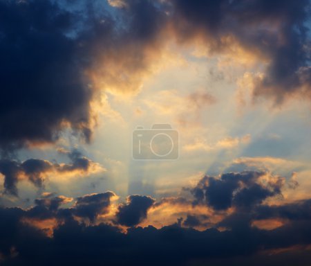 Cumulus clouds on sunset sky background