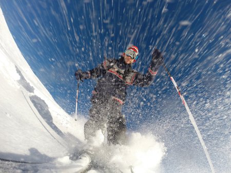 Downhill alpine skiing at high speed on powder snow.