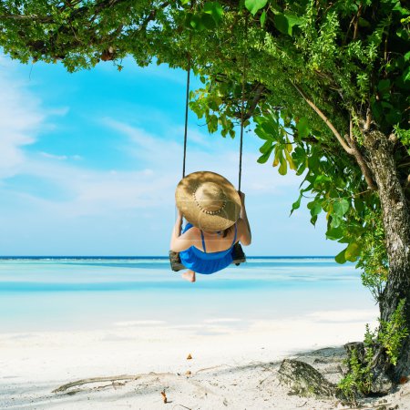 Woman   swinging at beach