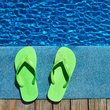 Sandals by a swimming pool