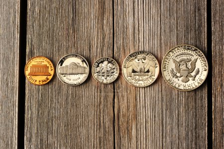 US cent coins over wooden background