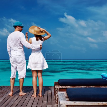 Couple on a beach jetty at Maldives