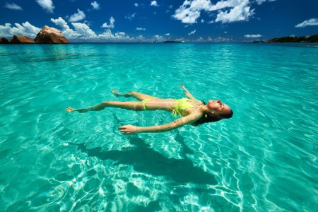 Woman in bikini lying on water 