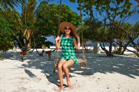 Woman in green dress at beach
