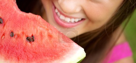 Fine picture presenting girl eating a watermelon