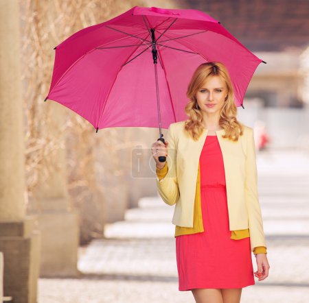 Smart woman waling with umbrella