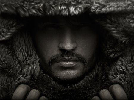Portrait of a young man in fur hood