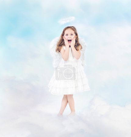 Surprised cheerful little girl among clouds