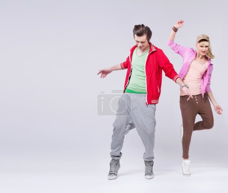 Relaxed couple of teenager in dance pose