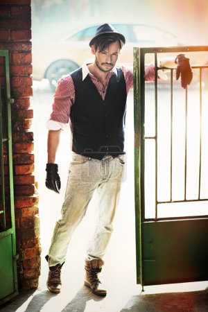 Fashion style man in the old wicket gate