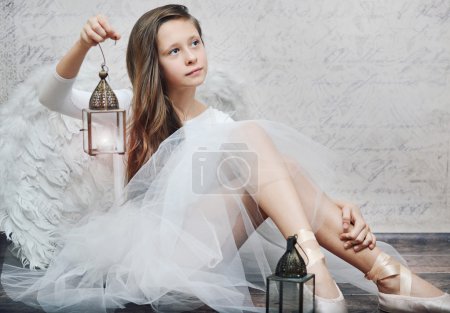 Art photo of young ballet dancer with lamp