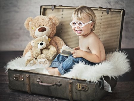 Funny picture of little boy in suitcase