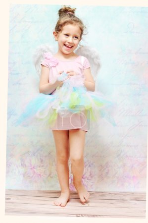 Little cheerful girl with white wings