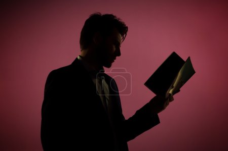 Attractive man reading the book