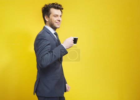 Cheerful businessman during the coffee break