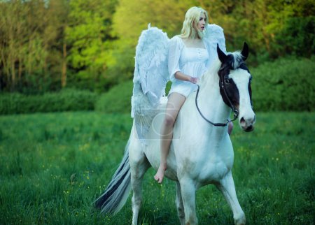 Bare feet angel riding a horse