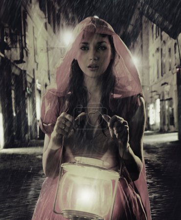 Black-white photo with colorful lady with lantern
