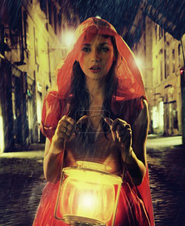 Innocent woman in red holding the lantern