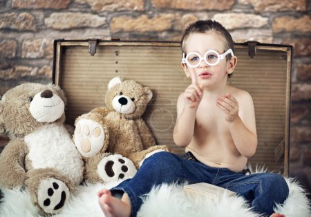 Small cute kid with teddybears