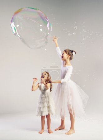 Two sisters with the large soap bubble
