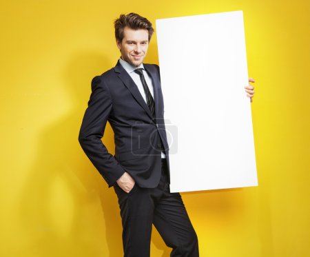 Handsome gentleman carrying white board