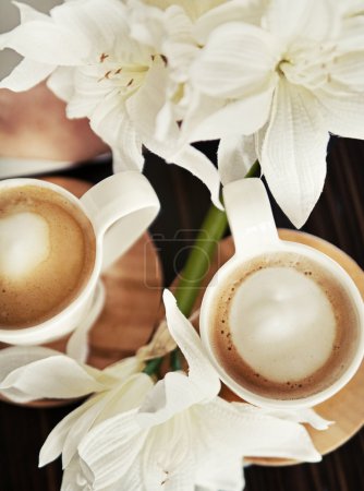 Cups of coffee with flowers