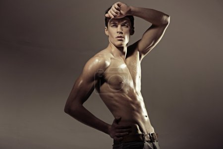 Hal-naked muscular athlete man .