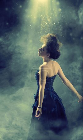 Glamour lady dancing in the fogg