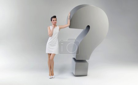 Attractive and astonished woman leaning against the question mar