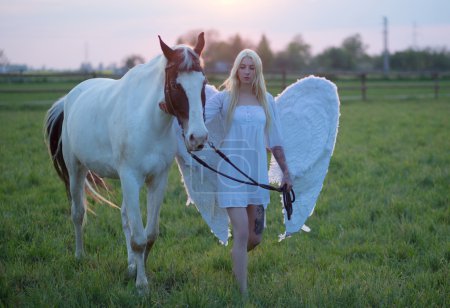 Sensual angel walking with the horse