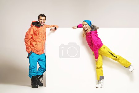 Attractive couple wearing colorful winter clothes