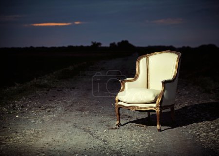 Antique chair let on the road
