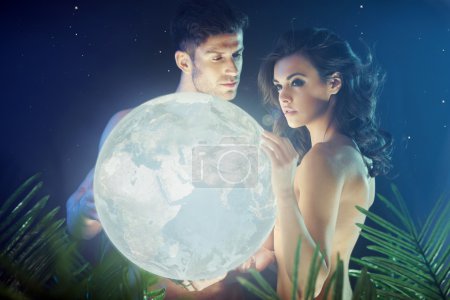 Conceptual photo of the couple holding the Earth