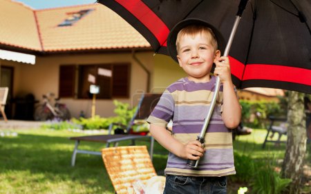 Image of a little boy with a big umbrella