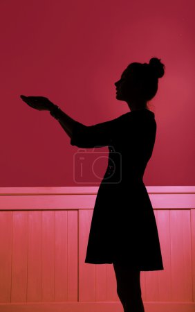 Silhouette of woman extending the hands