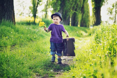 Little gentleman with huge suitcase