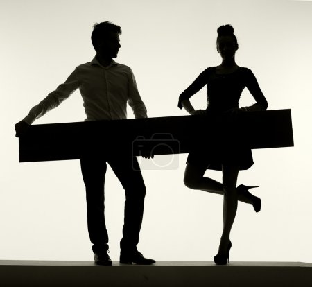 Elegant couple holding the empty board