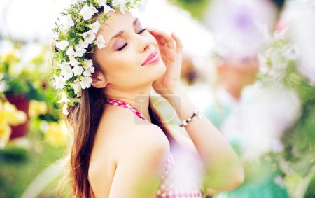 Pretty brunette lady with the colorful wreath on the head