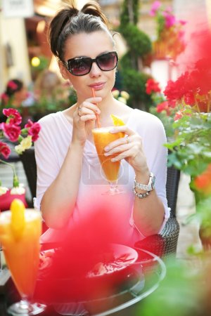 Thirsty lady drinking an orange juice