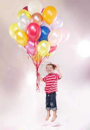 Cute small kid hovering by the ballons
