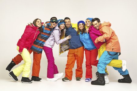 Group of cheerful snowboarders friends