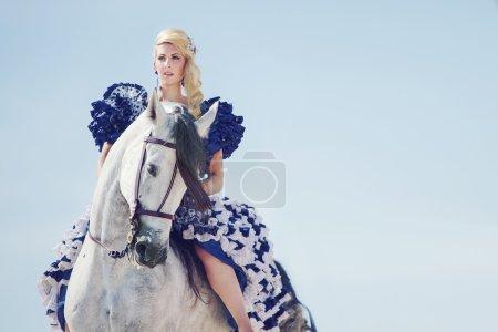 Portrait of the blonde riding a horse