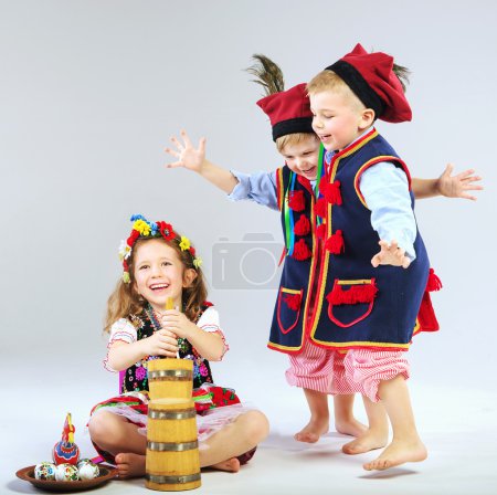 Three little friends wearing traditional costumes