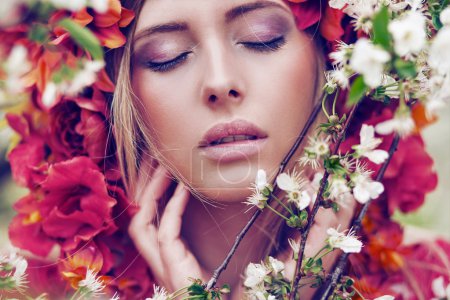 Sensual blonde woman with flowers