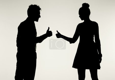 Young and peaceful couple showing OK gesture