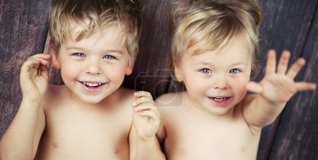 Two little boys smiling at the camera