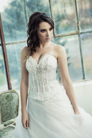 Sensual bride wearing pretty wedding gown
