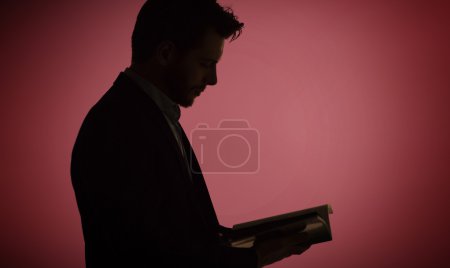 Portrait of the man reading a magazine