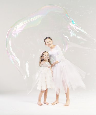 Two sisters with the soap bubble